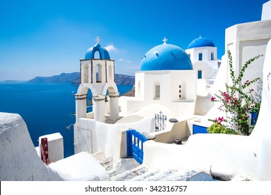 Scenic view of traditional cycladic white houses and blue domes in Oia village, Santorini island, Greece