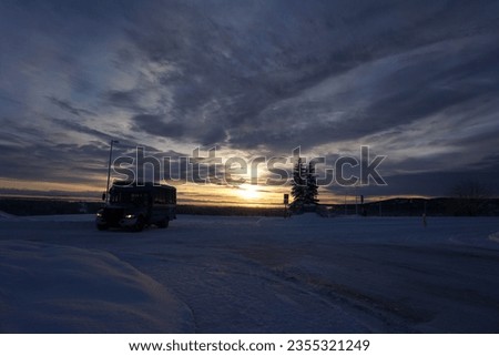 A scenic view of a truck in the nature of Alaska at sunset