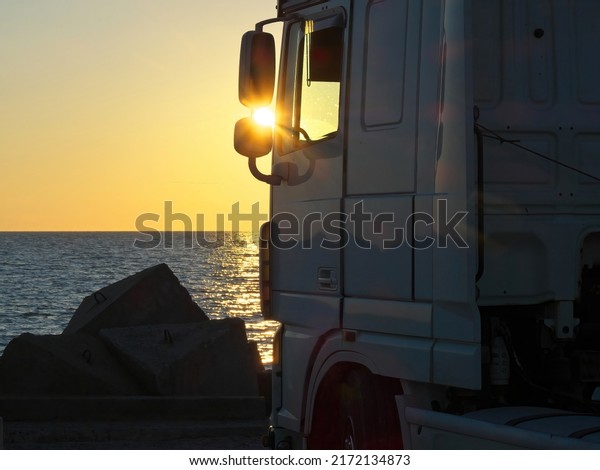 Scenic view  truck. Truck on the\
breakwater. Warm morning evening sunrise sun sky sunset.\
