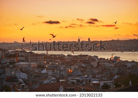 Scenic view of Uskudar district on the Asian side of Istanbul, Turkey with Blue Mosque and Hagia Sophia on the horizon over the Bosphorus strait with dramatic sky during sunset