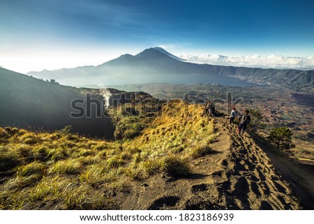 Scenic view of volcano Batur caldera hiking during sunrise. In the background mt.Agung. Ubud, Bali, Indonesia Stock photo © 