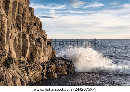 Scenic view of wave hitting on Halsanefhellir cave with basalt rock formation on black sand beach in Reynisfjara beach at Vik, Iceland