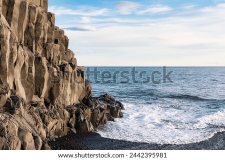 Scenic view of wave hitting on Halsanefhellir cave with basalt rock formation on black sand beach in Reynisfjara beach at Vik, Iceland
