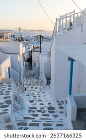 Scenic views of Mykonos, Greece featuring iconic whitewashed buildings, blue domes, windmills, cobbled streets, and vibrant coastal landscapes under bright Mediterranean sunlight.