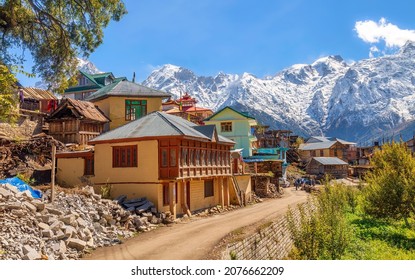 Scenic village road with residential houses and view of Kinnaur Kailash Himalaya mountain range at Kalpa, Himachal Pradesh India
