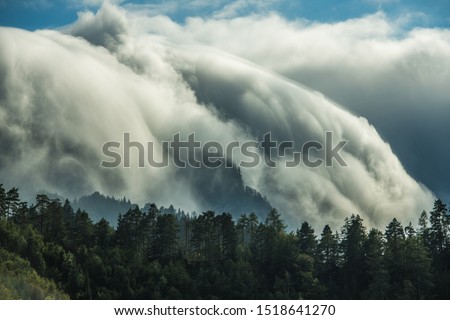 Scenic Waterfall-Like Orographic Clouds in Julian Alps, Slovenia. Meteorological Phenomena.