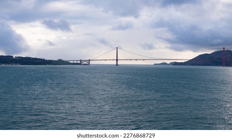 Scenic waterscape with bridge structure over sea water under cloudy sky, golden gate - Shutterstock ID 2276868729