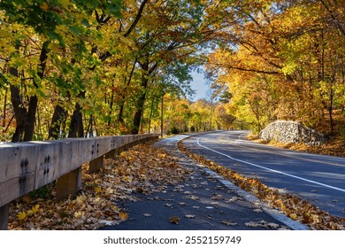 Scenic winding road surrounded by colorful fall foliage in Watertown, Massachusetts, USA - Powered by Shutterstock