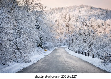 Scenic Winter Road Through Icy Forest Covered In Snow After Ice Storm And Snowfall. Ontario, Canada.