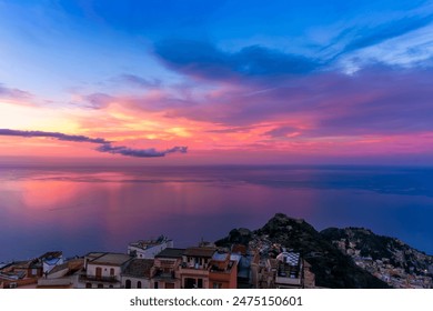 sceniv view from above to a high mountain town to amazing landscape of sea coast, roofs in vintage style of Italy and beautiful colorful sunset or sunrise cloudy sky - Powered by Shutterstock