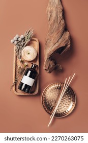 Scented oil for home with rattan sticks, luxury home perfume with woody and flowers fragrance. Vertical, top view photography.