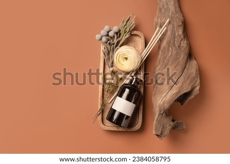 Scented oil for home with rattan sticks, luxury home perfume with woody and flowers fragrance. Background with copy space.