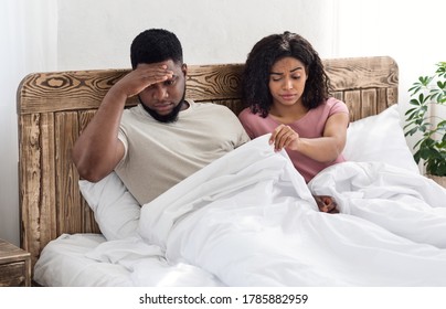 Sceptic African Woman Pulling Blanket Up, Upset Husband Having Sexual Issue, Bedroom Interior