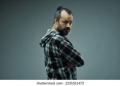 Sceptical man exclaiming What? are you serious? as he looks back over his shoulder at the camera with an incredulous expression - Shutterstock ID 2235351473