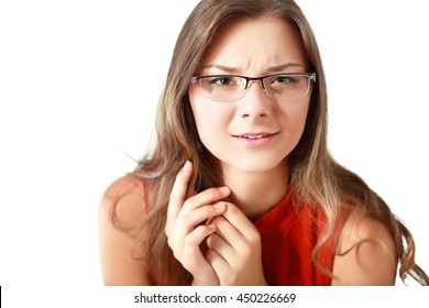 Sceptical young woman raising her eyebrow and looking at the camera with a look of disbelief and incredulity