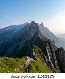 Schaefler mountain ridge swiss Alpstein, Appenzell Switzerland, steep ridge of the majestic Schaefler peak, Switzerland. couple man and woman mid age in the mountains, man and woman hiking 