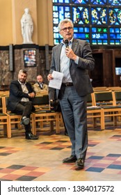 Schaerbeek, Brussels / Belgium - 04 26 2019: Mayor Bernard Clerfayt speeching to a crowd during the event around the renovation og the Saint Suzanna art deco church
