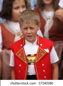 SCHAFFHAUSEN, SWITZERLAND - JULY 3, 2013: An unidentified boy, in traditional Swiss costume, is yodeling at the 27th North-West.