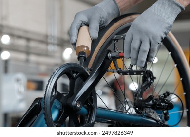 Scheduled maintenance of the bike at the service center. An auto mechanic lubricates the chain. - Powered by Shutterstock