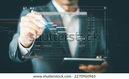Scheduling activities with planning software, Project manager working with Gantt chart schedule to plan tasks and deliverables. Corporate strategy for finance, operations, sales, and marketing.