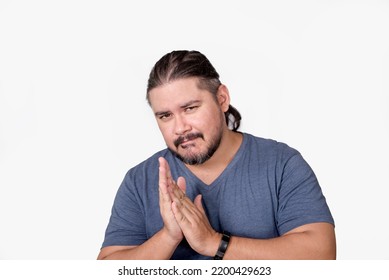 A scheming and cunning man rubs his palms together seeing his master plan coming into fruition. Isolated on a white background. - Shutterstock ID 2200429623