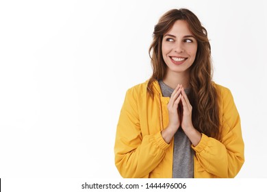 Scheming evil plan. Smart creative young mysterious girl twiddles fingers thinking excellent idea smiling look aside pondering devious scheme, standing white background thinking