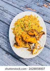 Schezwan Chicken Fried Rice in white platter at dark wooden background. Szechuan Rice is indo-chinese cuisine dish with bell peppers, green beans, carrot, chicken breasts.