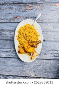 Schezwan Chicken Fried Rice in white platter at dark wooden background. Szechuan Rice is indo-chinese cuisine dish with bell peppers, green beans, carrot, chicken breasts.