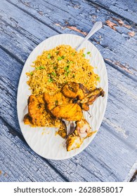 Schezwan Chicken Fried Rice in white platter at dark wooden background. Szechuan Rice is indo-chinese cuisine dish with bell peppers, green beans, carrot, chicken breasts.