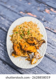 Schezwan Chicken Fried Rice in white platter at dark wooden background. Szechuan Rice is indo-chinese cuisine dish with bell peppers, green beans, carrot, chicken breasts.