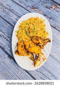 Schezwan Chicken Fried Rice in white platter at dark wooden background. Szechuan Rice is indo-chinese cuisine dish with bell peppers, green beans, carrot, chicken breasts.