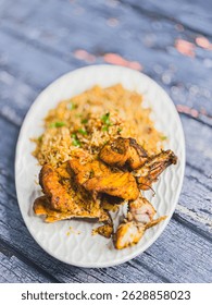 Schezwan Chicken Fried Rice in white platter at dark wooden background. Szechuan Rice is indo-chinese cuisine dish with bell peppers, green beans, carrot, chicken breasts.