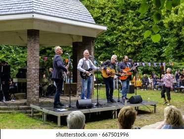 Schiedam, Netherlands, June 2017. Five Piece Rock Band Of Older Musicians, Performing At A Small Scale Outdoor Concert In The Park. Selective Focus