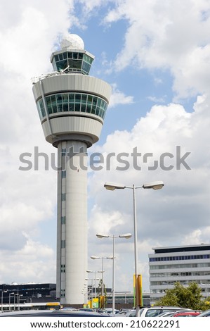 Schiphol airport control tower against cloudy sky
