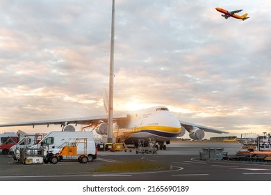 Schkeuditz, Germany - 29th May, 2022 - Laege An-124-100 ukrainian Ruslan Antonov cargo jet parked on Leipzig Halle airport terminal tarmac apron for loading and service. DHL hub sunset background