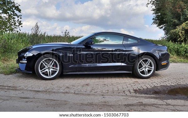Schleswig-Holstein, Germany - September\
13, 2019: Ford Mustang 2018 black sports car sunny day\
view