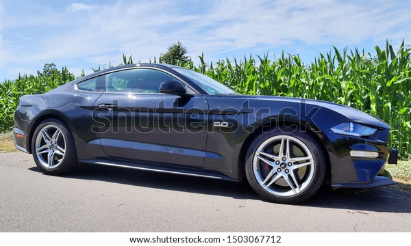 Schleswig-Holstein, Germany - September
13, 2019: Ford Mustang 2018 black sports car sunny day
view