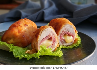 Schnitzel cordon bleu, chicken cutlet wrapped around ham and cheese, breaded and fried.