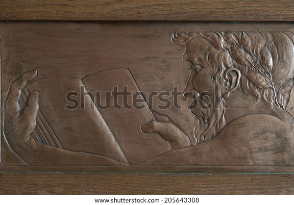 Scholar reading a book, engraving, a symbol of\
science and wisdom.