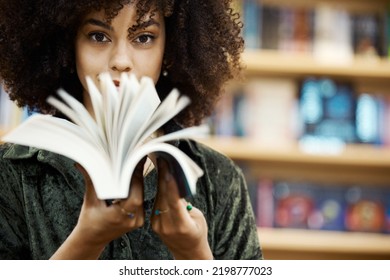 Scholarship, books and girl student in library learning, studying and reading educational knowledge or information. Young, smart and afro black woman on university or college campus with school novel