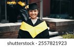 Scholarship, portrait and graduation for woman, smile and celebration of education, event and confident. Outdoor, success and person with knowledge, proud and cap for ceremony, happy and degree