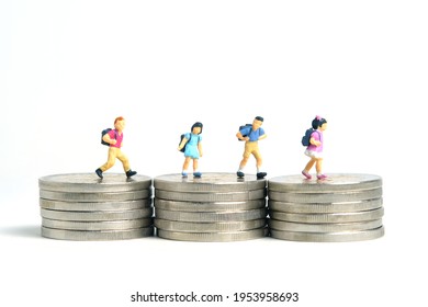 School admission budget.  Children or kids, walking above golden coin money stack. Miniature tiny people toys photography. isolated on white background.