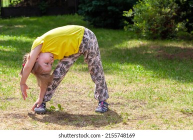 School Age Child, Girl Exercising, Stretching In The Garden Outdoors, Backyard Physical Exercise, Stretches. Kids Keeping Fit, Healthy Active Childhood Health Care Lifestyle Simple Concept, Summer