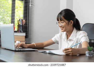 School age student doing her homework with digital tablet at home, child using gadgets to study education and distance learning for homeschool children during quarantine at home entertainment. - Powered by Shutterstock