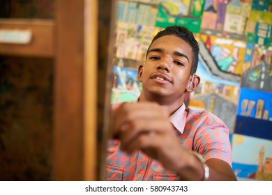 School of art, college of arts. Portrait of happy black boy smiling, learning to paint and looking at camera. - Powered by Shutterstock