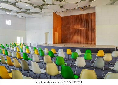 School Assembly Hall With Stage For Performance  And Rows Of Seats