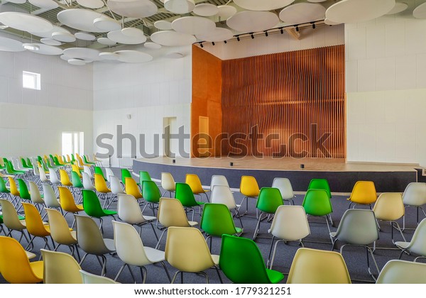 School assembly hall with stage for performance \
and rows of seats