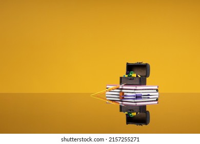 School background with colored tassels and cubes in a chest on a stack of books. The concept of back to school, academic education in institutes, the beginning of a new academic year, student life.