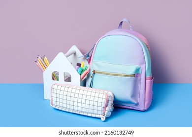 School backpack and House shaped pencil holder with color pencils and pens on the table. House Pen Holder with notebooks. Creative Organizing. Concept back to school. - Powered by Shutterstock