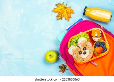 School Backpack And Kids Lunch Box With Funny Bear Sandwich And Boiled Egg Bee, Apple, Orange Juice. Back To School Background. Copy Space